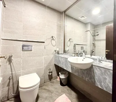 a bathroom with a toilet and a sink at Al Manara Premium Cozy Studio in Dubai