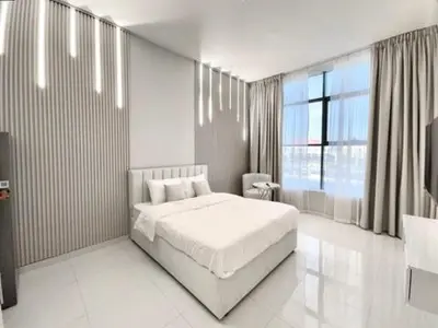 a white bedroom with a bed and a large window at Al Manara Premium Lux Studio in Dubai