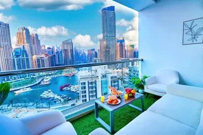 a living room with a view of a city skyline at Barsana - Seaside Luxury 2BDR - Panoramic Marina & Sea Views in Dubai