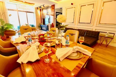 a dining room table with plates and wine glasses at Barsana - Seaside Luxury 2BDR - Panoramic Marina & Sea Views in Dubai