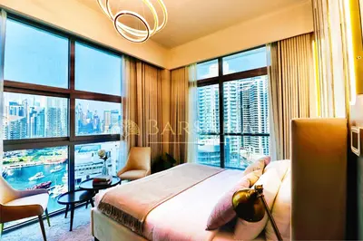 a bedroom with a bed and a view of a city at Barsana - Seaside Luxury 2BDR - Panoramic Marina & Sea Views in Dubai