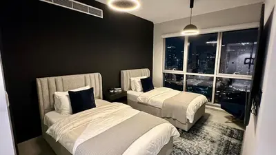 a hotel room with two beds and a window at Ultimate 5BR Luxury I 2500 sqf I Burj Inner Circle in Dubai