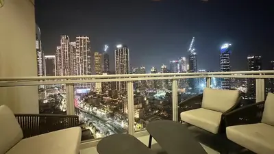 a room with a view of a city at night at Ultimate 5BR Luxury I 2500 sqf I Burj Inner Circle in Dubai