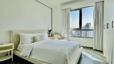 a white bedroom with a bed and a large window at Ultimate 5BR Luxury I 2500 sqf I Burj Inner Circle in Dubai