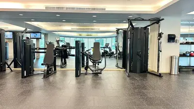 a gym with treadmills and machines in a building at Luxury in the Sky - 1BR Burj Inner Circle in Dubai