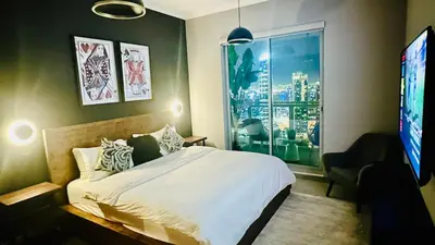 a bedroom with a white bed and a window at Luxury in the Sky - 1BR Burj Inner Circle in Dubai