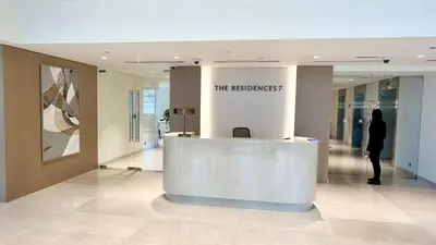 a woman standing at a reception desk in a building at Luxury in the Sky - 1BR Burj Inner Circle in Dubai