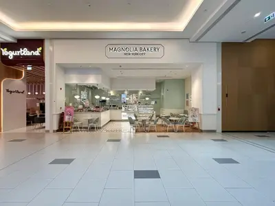 a mall with chairs and tables in a store at Trophy-Brandnew Premium and Vibrant 1BR in JVC in Dubai