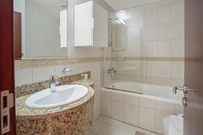 a bathroom with a sink and a bath tub at 28- Luxury Princess Tower Marina Apartment with Sea View, Pool & Balcony in Dubai
