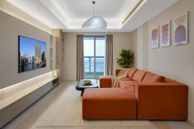 a living room with a couch and a table at 28- Luxury Princess Tower Marina Apartment with Sea View, Pool & Balcony in Dubai