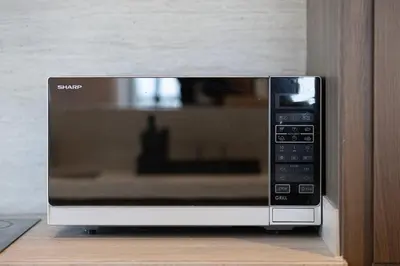 a microwave oven sitting on top of a counter at Mahogany 4 - 2BR 6PAX - Panoramic Burj Khalifa View in Dubai