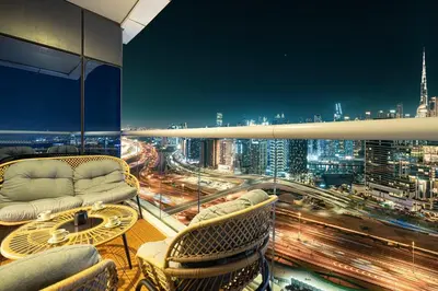 a room with a view of a city at night at Mahogany 4 - 2BR 6PAX - Panoramic Burj Khalifa View in Dubai