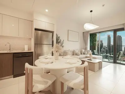 a kitchen and living room with a white table and chairs at Burj Royale Suites by Prestige Nest in Dubai