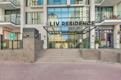 a building with a sign that readsfluk residence at Luxury new studio Dubai Marina 10min to the beach in Dubai