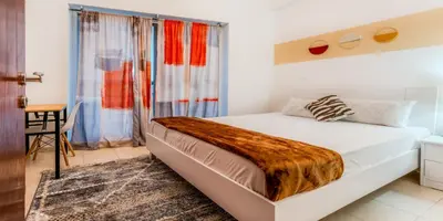 a bedroom with a large white bed in a room at 1 BR Spacious Apartment - JLT in Dubai