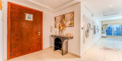 a living room with a wooden door and a fireplace at 1 BR Spacious Apartment - JLT in Dubai