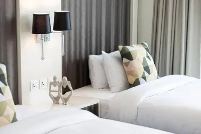 a hotel room with a couple sitting on a bed at Bay's Edge, Luxury Canal View 2BR in Business Bay in Dubai