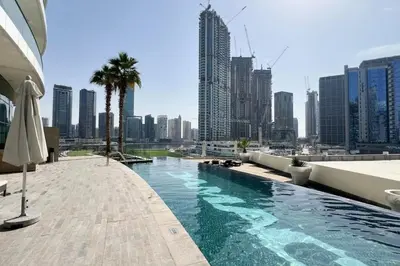 a swimming pool in a city with tall buildings at Bay's Edge, Luxury Canal View 2BR in Business Bay in Dubai