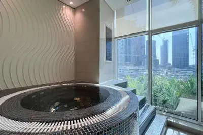 a hot tub in a building with a view at Bay's Edge, Luxury Canal View 2BR in Business Bay in Dubai