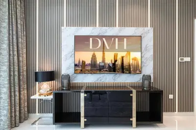 a living room with a tv on a table at Bay's Edge, Luxury Canal View 2BR in Business Bay in Dubai
