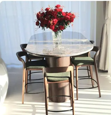 a glass table with a vase of red flowers on it at Spacious 3BR, Private Beach Access in Dubai
