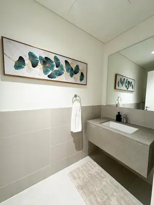 a bathroom with a sink and a mirror at Spacious 3BR, Private Beach Access in Dubai