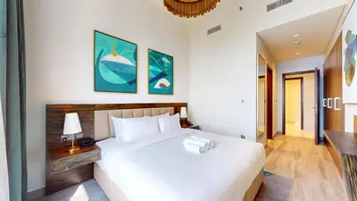 a bedroom with a large white bed in a room at Locations I Avani Palm View I Luxury 2 Bedroom I Sea View I Pool, Gym, Parking, Wi-Fi in Dubai