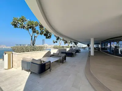 a row of chairs and tables in a building at Grand Bleu - Luxurious One Bedroom with Sea View in Dubai