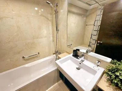 a bathroom with a sink and a bath tub and a sink at SUNRISE HOMES - A Stylish Studio in Botanica Tower in Dubai
