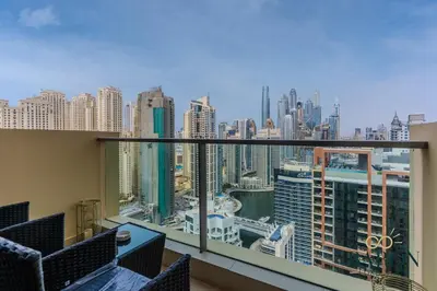 a balcony with chairs and a view of a city at The Chic in Dubai