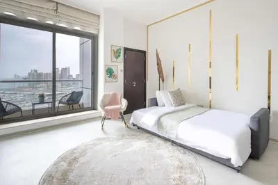 a bedroom with a bed and a large window at Frank Porter - Botanica Tower in Dubai