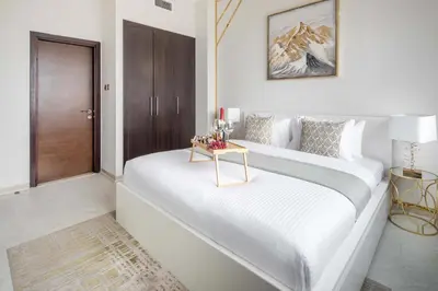 a bedroom with two beds with a table on it at Frank Porter - Botanica Tower in Dubai