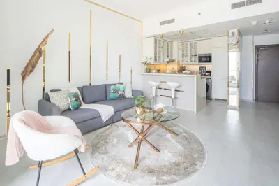 a living room with a couch and a table at Frank Porter - Botanica Tower in Dubai