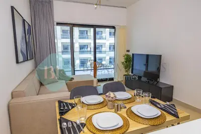 a living room with a table and a couch at Bloomfields Stylish 1Br In Binghatti Creek Jaddaf in Dubai