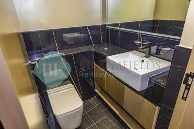 a bathroom with a toilet and a sink at Bloomfields Stylish 1Br In Binghatti Creek Jaddaf in Dubai