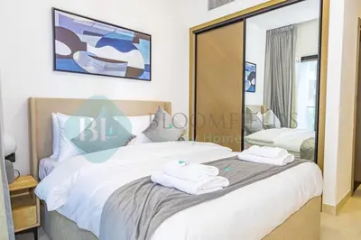 a bedroom with a large bed with towels on it at Bloomfields Stylish 1Br In Binghatti Creek Jaddaf in Dubai