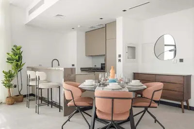 a kitchen and dining room with a table and chairs at Silkhaus Highfloor 1BDR in 15 Northside Tower in Dubai