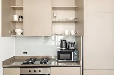 a kitchen with a stove and a microwave at Silkhaus Highfloor 1BDR in 15 Northside Tower in Dubai