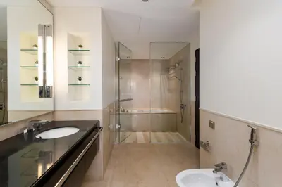 a bathroom with a glass shower and a sink at Address Dubai Marina, Dubai Marina - Mint Stay in Dubai