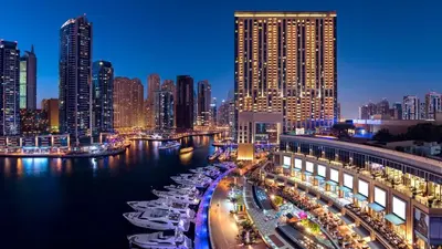 a city at night with boats in the water at Address Dubai Marina, Dubai Marina - Mint Stay in Dubai