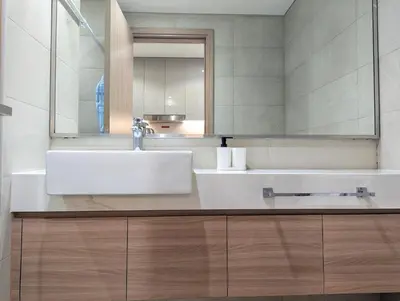 a bathroom with a white sink and a mirror at Fully Furnished Modern Studio Apartment Nearby Meydan Racecourse in Dubai