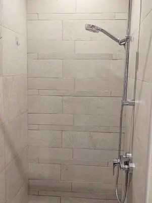 a shower with a glass door in a bathroom at Fully Furnished Modern Studio Apartment Nearby Meydan Racecourse in Dubai