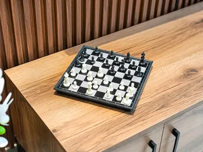 a chessboard sitting on top of a wooden table at Luxury Apartment In the Heart of Dubai Marina in Dubai