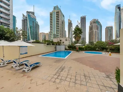 a pool in the middle of a city with tall buildings at Luxury Apartment In the Heart of Dubai Marina in Dubai