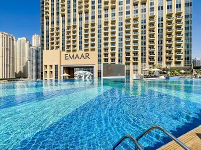 a large swimming pool in front of a building at Cosmos Living Studio at JW Marina in Dubai