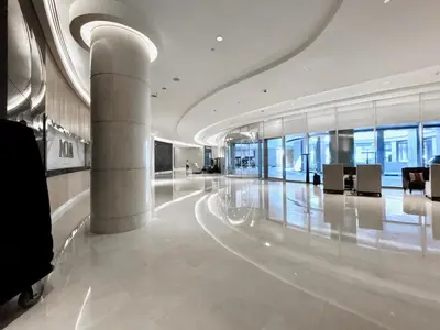 a lobby of a building with columns and chairs at Cosmos Living Studio at JW Marina in Dubai