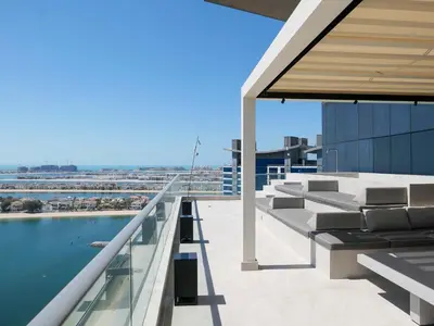 a balcony with couches and a pool on a building at High End 4BR Penthouse with Private Pool and Skyline Views in Dubai