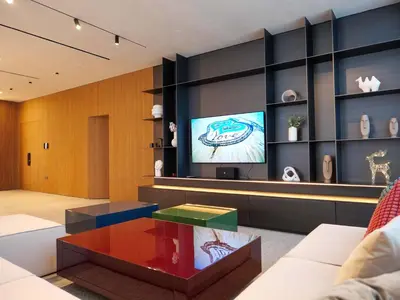 a living room with a tv and a coffee table at High End 4BR Penthouse with Private Pool and Skyline Views in Dubai