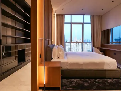 a bedroom with a bed and a large window at High End 4BR Penthouse with Private Pool and Skyline Views in Dubai