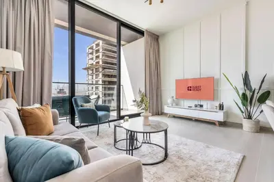 a living room with a couch and a tv at GuestReady - Modern retreat in JVC in Dubai